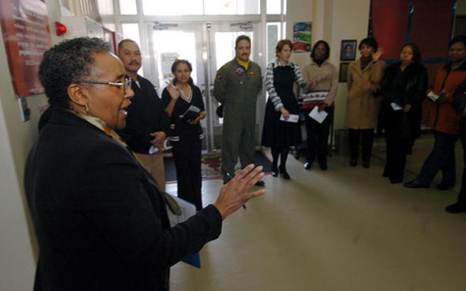 Pattie Phipps, Principal of Shirley Lanham Elementary School at Naval Air Facility Atsugi, talks to volunteers that are in a mentoring program sponsored through the school.