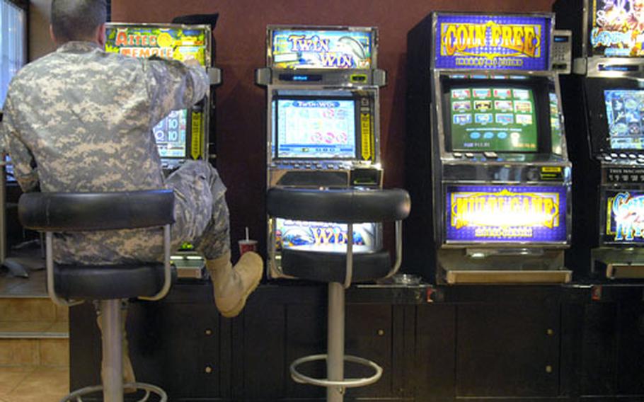 A soldier tries his luck at one of the slot machines Dec. 17 at the Striker’s Bowling Center in Baumholder, Germany.