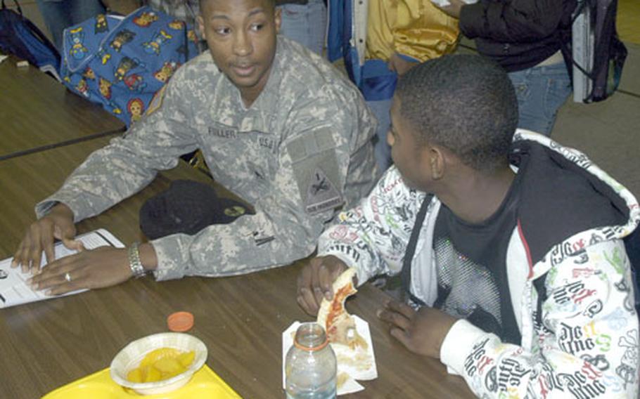 Staff Sgt. Marcus Fuller and his son Zachary chat Tuesday during lunch at Baumholder Middle School and High School. School officials organized a deployment day at the school to give families extra time together before the 2nd Brigade, 1st Armored Division deploys to Iraq this spring.