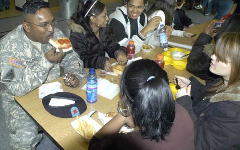 Sgt. First Class Deoraj Baldeo spent the afternoon at Baumholder Middle School and High School Tuesday with his daughters Melissa and Tiffany and their friends. Parents also were allowed to sit in on classes as part of a pre-deployment event at the school.