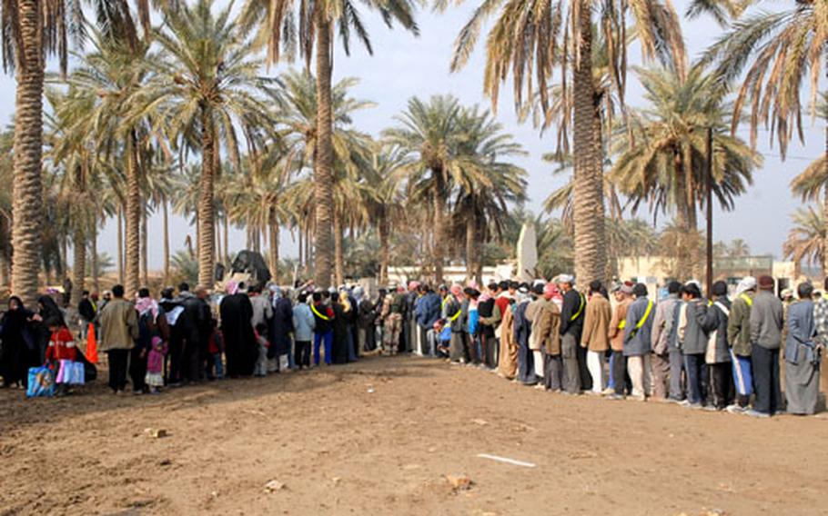 Residents of Khidr, a village northwest of Iskandariyah, line up outside a medical clinic held by U.S. troops on Monday. Much of the village was destroyed in December during fighting between U.S. troops and al-Qaeda in Iraq, the military says.
