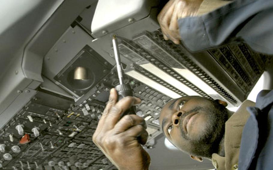Air Force Staff Sgt. Cedric Austin, an aircraft electric and environmental journeyman with the 723rd Air Mobility Squadron, re-attaches a fuse panel in a C-17 cockpit Tuesday on the flight line at Ramstein Air Base, Germany. The first of two C-17s from Air Mobility Command will begin staging missions out of Ramstein on Friday. Up to four aircrews from various reserve units will be filling Air Expeditionary Force rotations, saving money on trans-Atlantic flights for missions within Europe and Africa.