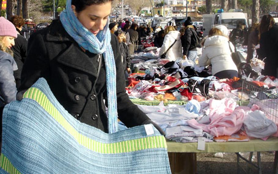 Shawnie Green inspects some of the wares at the Possilipo market, one of many outdoor markets in Naples.