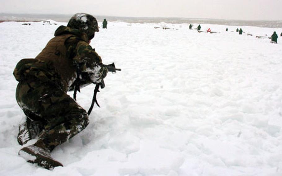 Lance Cpl. Gorel Flores runs and drops into snow while practicing maneuvers Wednesday at Camp Fuji, Japan. This was the first time Fuji NCOs planned an event like this for their junior Marines, and they weren&#39;t expecting snow.