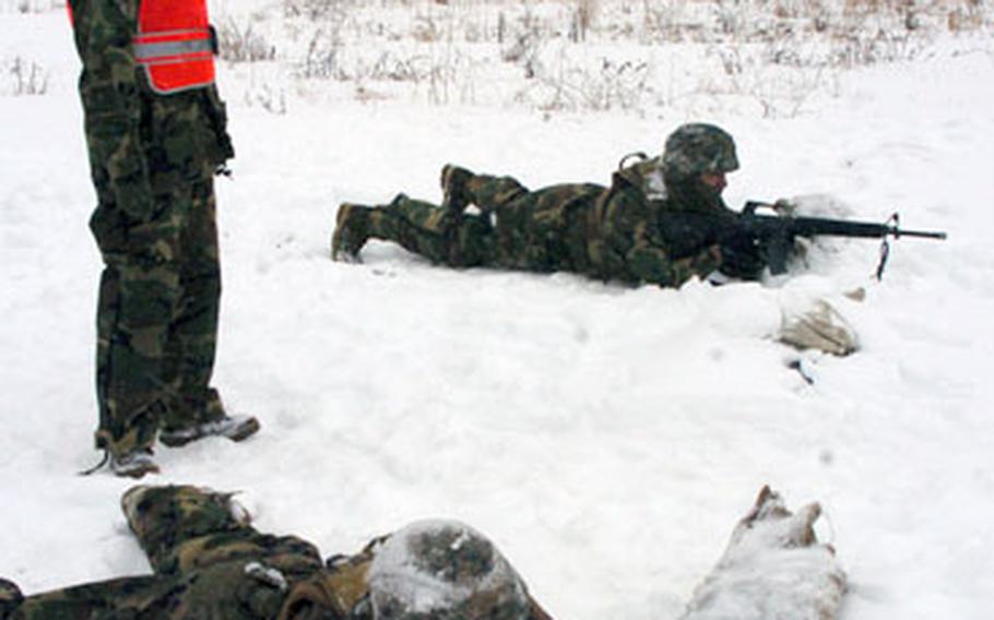 Cpl. Nicole Powers instructs Pfc. Gilbert Monsibais(cq) and Lance Cpl. Joseph Aorahim(cq) on how to attack during a practice drill in the snow Wednesday at Camp Fuji, Japan.