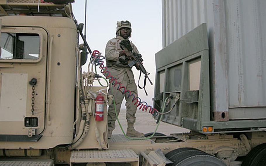 Staff Sgt. Brian Lee, of the 100th Logistics Readiness Squadron at RAF Mildenhall, England, pulls security on top of a M915 tractor trailer during a mission in Iraq.