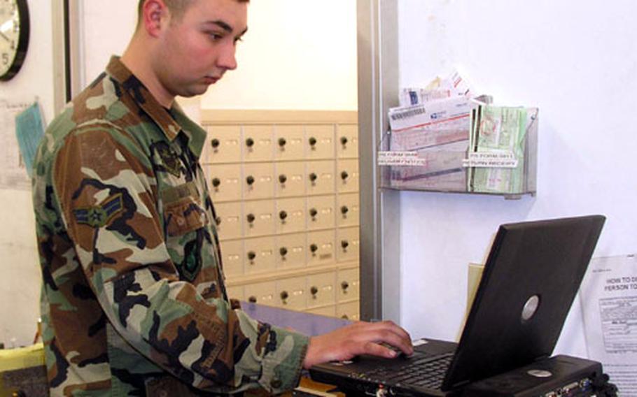 At Osan Air Base post office in South Korea on Friday, Airman 1st Class Justin Mays, a postal clerk, checks mail tracking data on a laptop computer. The computer is part of a digital mail tracking system Osan has been testing, slated to enter service this summer at five U.S. Air bases around the Pacific. Mays is with the 51st Communications Squadron.
