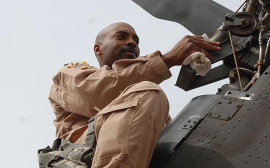 First Sgt. Marvin Meeks, 41, of El Dorado, Ark., checks the tail on a Black Hawk on Sunday after dropping off Gen. David Petraeus, senior American commander in Iraq, at Baghdad International Airport. Crews that fly VIPs like Petraeus keep the helicopters ready to go at a moment&#39;s notice.