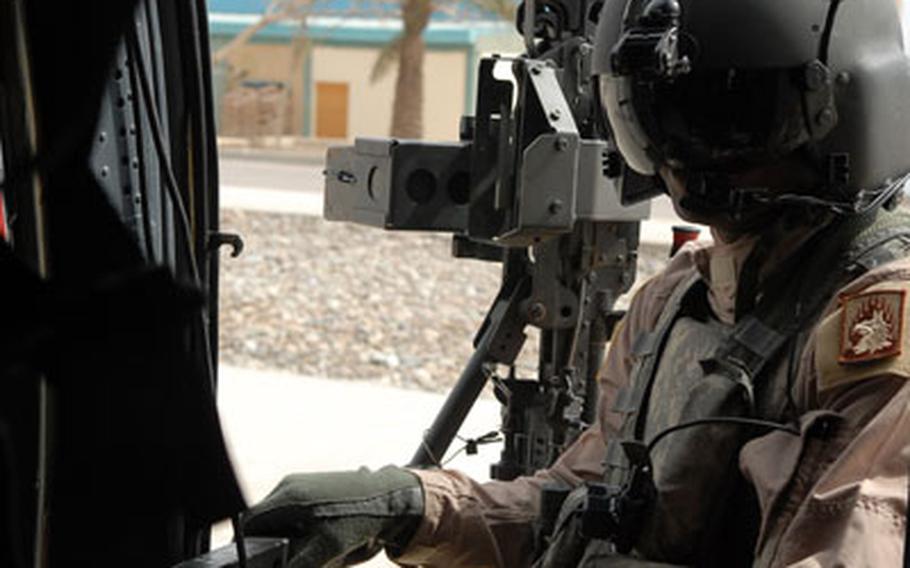 Meeks waits for Gen. David Petraeus to arrive at a helipad in Baghdad on Sunday. Meeks was a crew chief on one of two Black Hawks that fly Petraeus.