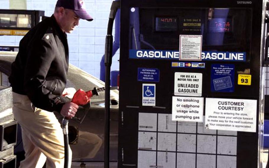 Chief Petty Officer James Sampson pumps gas into his car Thursday on Yokosuka Naval Base, Japan. Sampson, with three years at Yokosuka, says gas prices have jumped during his stay. “It just cost me 40 bucks to fill up this time," Sampson said. "It used to be 25 to 30 when I first got here in &#39;05."