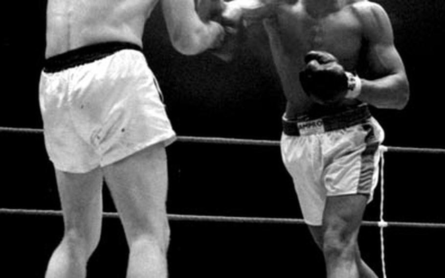Muhammad Ali lands a right to the head of Karl Mildenberger, moments before referee Teddy Waltham stops the fight in the 12th round on September 10, 1966.