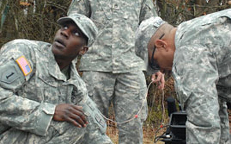 From left, Sgt. Christopher Knight, 24, Oscar Gonzalez, 26, and Sgt. 1st Class Jose Carmona, 46, emplace a mock IED Friday during training in Germany.