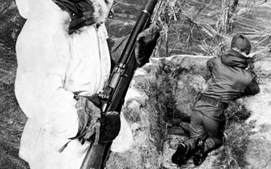 Soldiers from the 15th Republic of Korea Army stand guard at a frigid mountaintop outpost in the central sector of Korea's "no-man's land" in December, 1969.