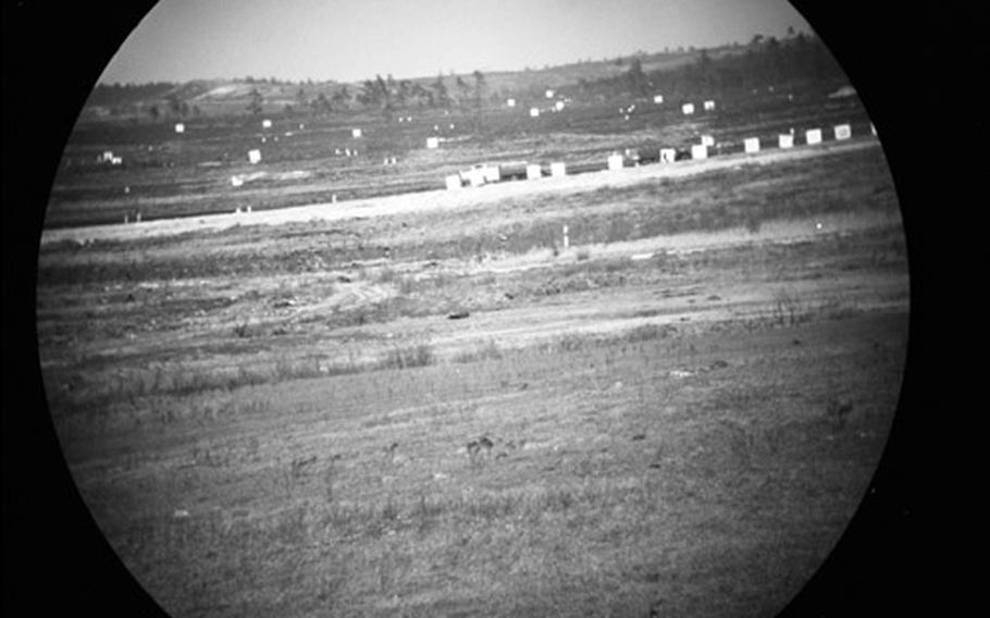 A view of the target area through the sighting scope of an M103 tank.