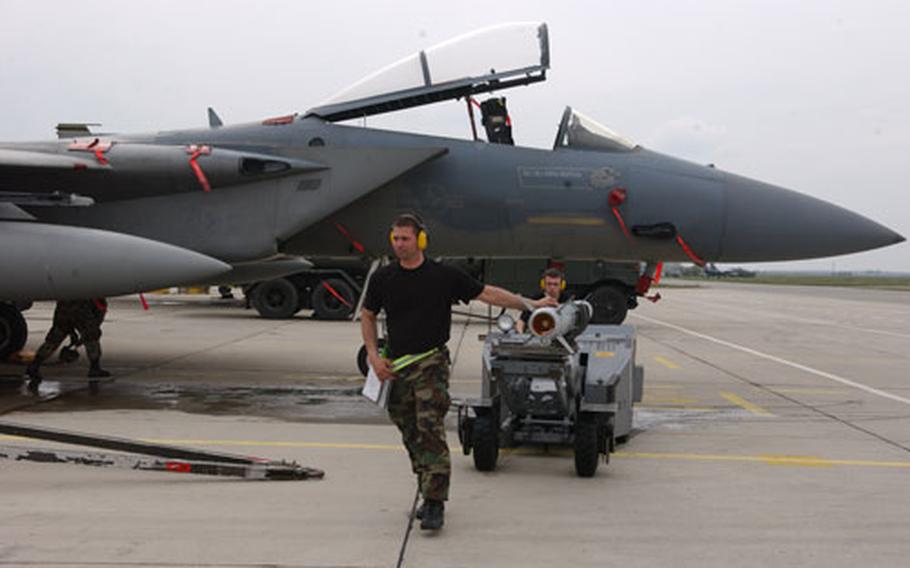 A weapon's specialist changes the aircraft's live munitions for the NATO summit in Bucharest, Romania, to training munitions in preparation for exercises that took place earlier this month with the Bulgarian air force.