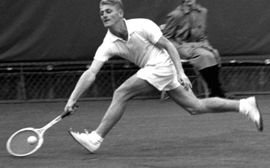 Lew Hoad lunges for the ball during his singles championship match against Art Larsen at Wiesbaden in May, 1956.