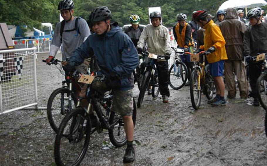 Master Sgt. Bill Eihusen, left, and Eric Crandell (74), both of Yokota Air Base, Japan, prepare for the start of the Men's Open event Saturday during the 21st Tour de Tama Mountain Bike Race at Tama Hills Recreation Center, Japan.