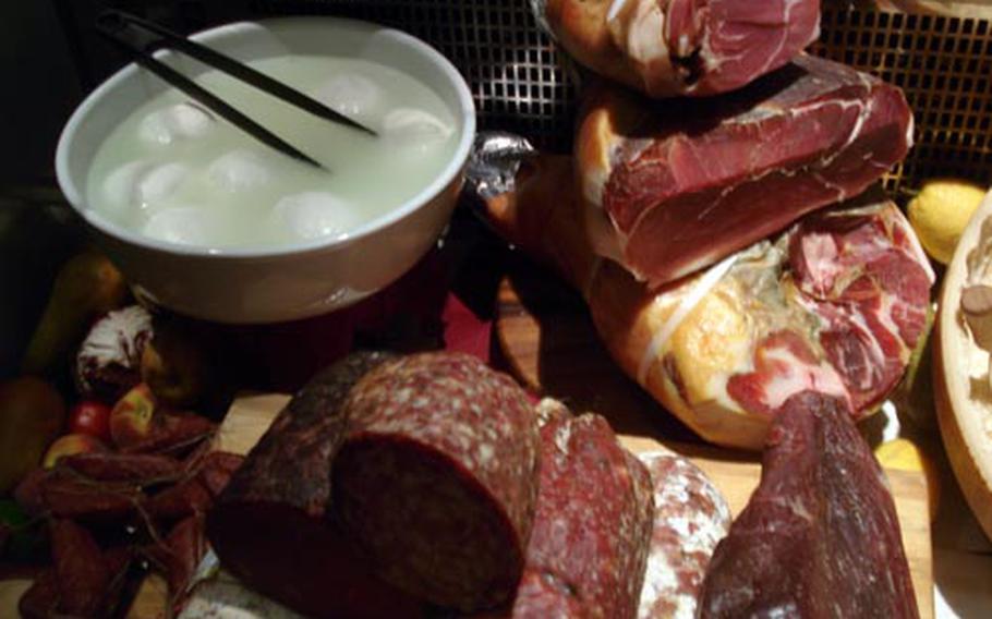 A case near the entrance of Florence's Golden View Open Bar restaurant displays the fresh foods used for many of the elegant restaurant's appetizer dishes -- fresh balls of Italy's famed mozzarella di bufala, smoke-cured hams, tasty salamis and more.