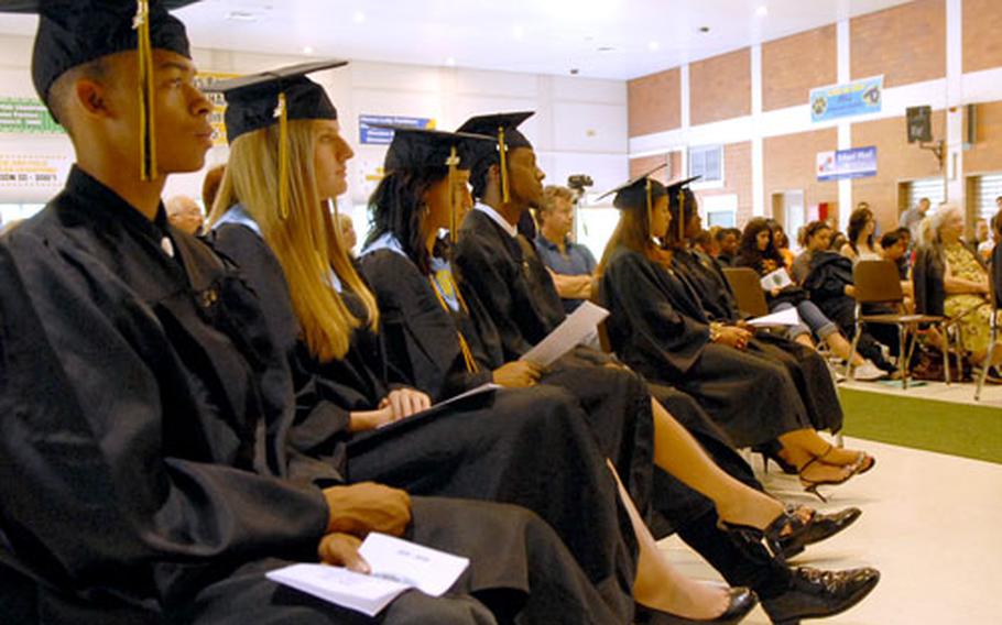 Members of the final senior class at Hanau High School listen to a speech by the first principal of the school, Tom Ellinger. With the drawdown of the Hanau Army garrison, the school is closing after 33 years.