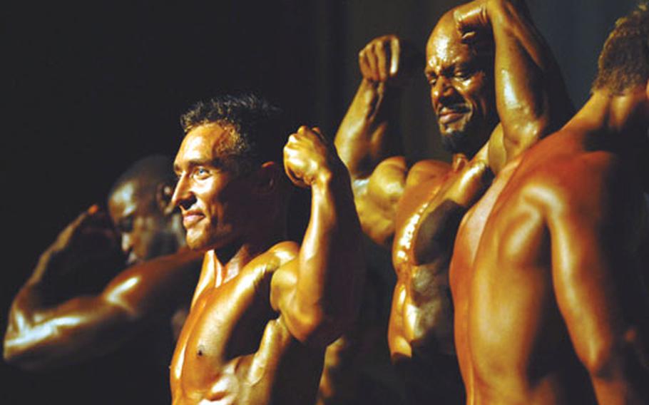 From left, men's light-heavyweight champion Timothy Martin, lightweight champion Ryan Baker, heavyweight champion Roosevelt Moody and middleweight champion Christopher Enos of Kadena Air Base engage in a posedown to determine the men's overall champion in the 2nd Pacific Muscle Classic bodybuilding competition. Moody won the award, and also the best poser award.