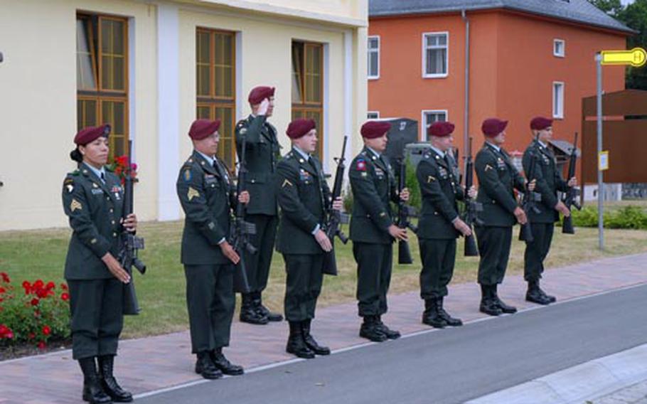 As "Taps" plays, a 173rd Airborne Brigade Combat Team honor guard stand at present arms during a Thursday memorial service on Warner Barracks in Bamberg, Germany, for Spc. James Matthew Finley, 21, and Pfc. Andrew Jon Shields, 19, members of the 173rd's Special Troops Battalion, who were killed by a roadside bomb in Jalalabad, Afghanistan, May 31.
