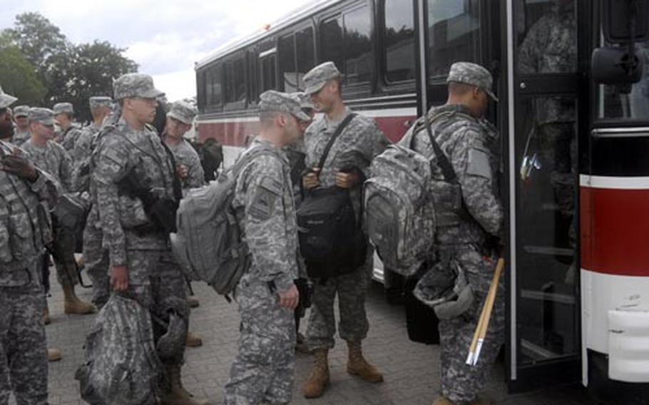 Soldiers with the 18th Combat Sustainment Support Battalion’s Headquarters Headquarters Company, the 51st Transportation Company and the 793rd Movement Control Team load a bus Friday in Kaiserslautern as they prepare to head to nearby Ramstein Air Base where they will board planes. The three units from the 21st Theater Sustainment Command will serve 15-month tours in Iraq.