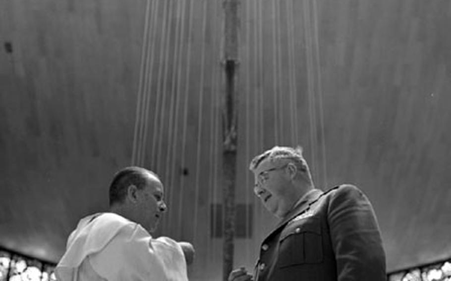 Father Santos Galinda with Catholic Chaplain (Maj) William L. Travers from the nearby U.S. military base.