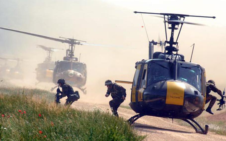 U.S. Hueys drop German personnel during air assault training Wednesday at Hohenfels, Germany.