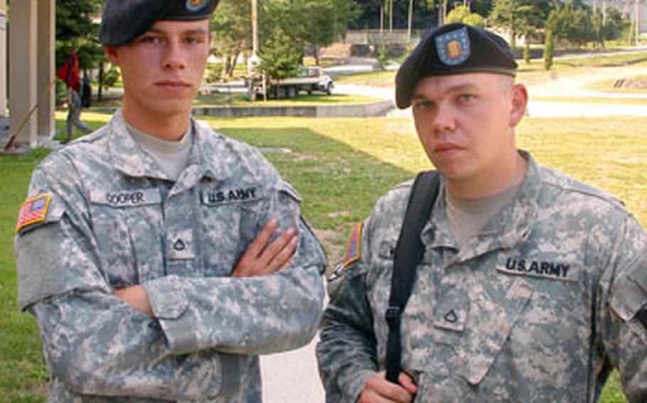 Pfc. Gary Cooper, left, and Pfc. Stephen Wanser stand at Camp Casey in front of Soyo Mountain — a place they used to go while under the influence of dextromethorphan, or DXM, which is found in over-the-counter cold medicines. In large doses, the drug is dissociative and can produce hallucinations.
