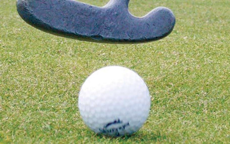 A golfer putts on the fifth hole of the Cambridge Lakes Golf Course.