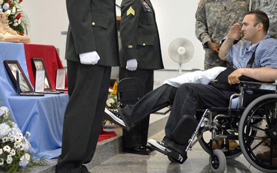 Army Cpl. Joseph Browning, assigned to 2nd Battalion, 6th Infantry Regiment, honors Capt. Gregory Dalessio and Pfc. Bryan Thomas during a memorial ceremony Tuesday at a chapel in Baumholder. Browning, two other soldiers and a civilian were wounded during the same attack that killed Dalessio and Thomas in Salman Pak, Iraq, outside of Baghdad.
