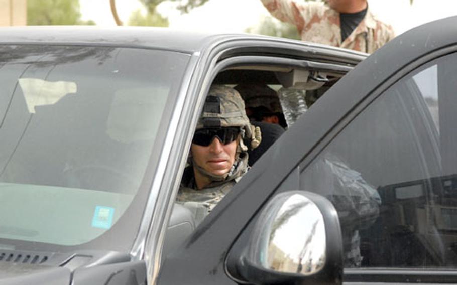 Lt. Col. Chris Vanek gets ready to drive an unarmored pickup into Hawijah’s market Tuesday at the invitation of Col. Khalaf Ibrahim Ali. Vanek’s spin in the pickup would have been unthinkable until recently. But stability has improved considerably since the Americans removed concrete walls and concertina wire from the city, despite some worries that their removal would just make a bad situation worse.