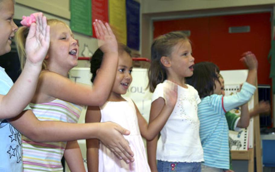 Four-year-olds in the "Sure Start" program at W.T. Sampson Elementary School sing for their mothers during a special Mother&#39;s Day presentation.