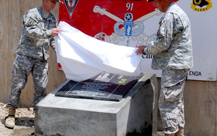 Lt. Col. Christopher D. Kolenda, left, and Command Sgt. Maj. Victor Pedraza, commander and command sergeant major of 1st Squadron, 91st Cavalry Regiment (Airborne), unveil a plaque dedicated to Maj. Thomas Bostick. It was part of a recent ceremony renaming Forward Operating Base Naray, Afghanistan.