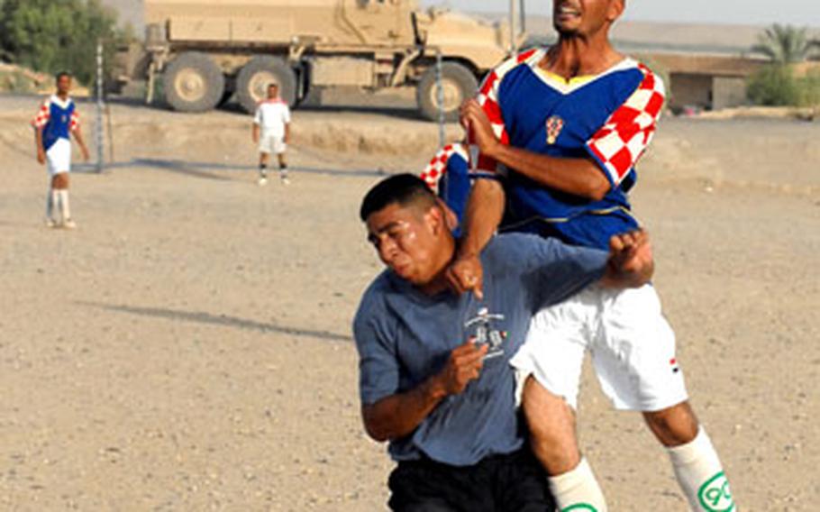Riyadh Abdullah beats Pfc. Hector Salinas for a header during the game between Sabagiya, Iraq, residents and American soldiers. Competition between the two teams was intense, even though it was a friendly match.