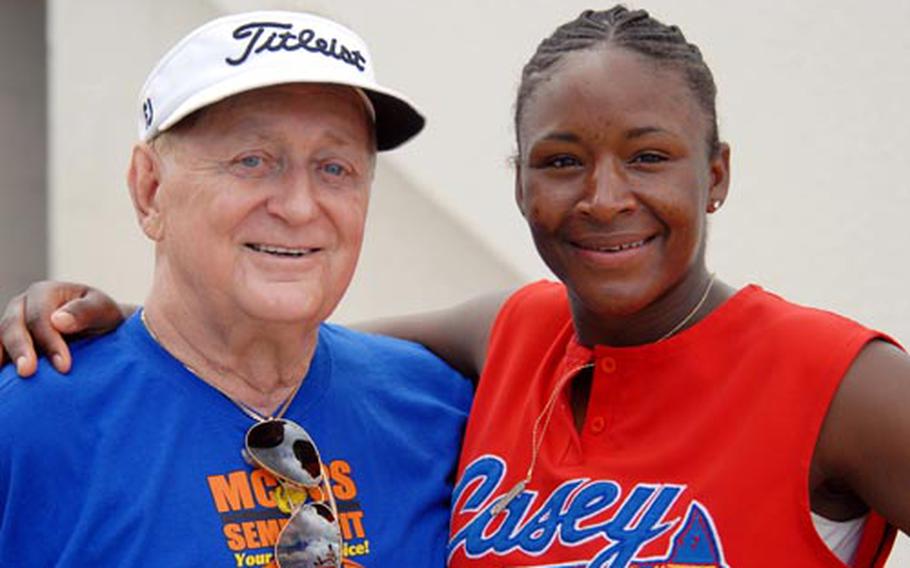 John Zivic, left, is reunited with Army medic Jacqueline Kershaw of South Korea's Camp Casey on Saturday during the 10th Firecracker Shootout Interservice Softball Tournament at Field 2, Foster Athletics Complex, Camp Foster, Okinawa. Kershaw is one of five people credited with saving the life of Zivic, a basketball referee for more than 40 years. He collapsed and suffered a heart attack during January's Martin Luther King Basketball Tournament; Kershaw, who played for Area I's basketball team, and four others rushed to his side to perform CPR.