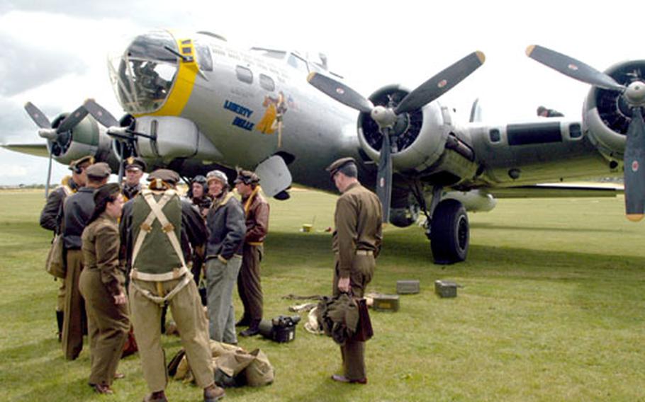 World War II re-enactors mingle Tuesday in front of Liberty Belle, a restored bomber. The B-17 traveled from Georgia to participate in an air show this weekend at the Imperial War Museum in Duxford, England.