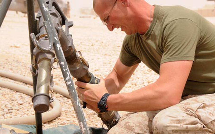 Lance Cpl. Brian Schrieber, 26, of Richmond, Va., goes about his business as one of four aircraft refuelers at a combat outpost in Rawah, Iraq. They pretty much eat and sleep at their jobs.
