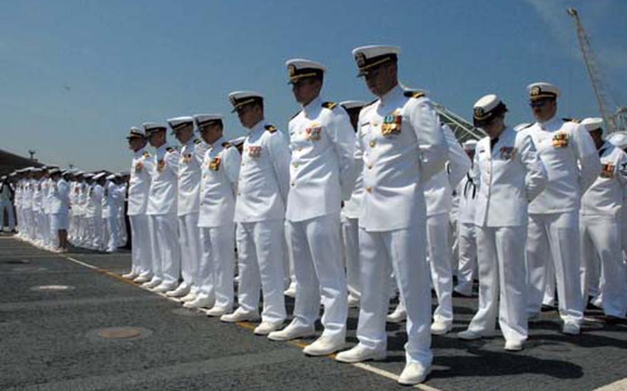 Sailors line the deck of the USS Denver at Sasebo Naval Base on Thursday. The ship sailed from the United States and exchanged with the USS Juneau after several weeks of work and a ceremony at the base.