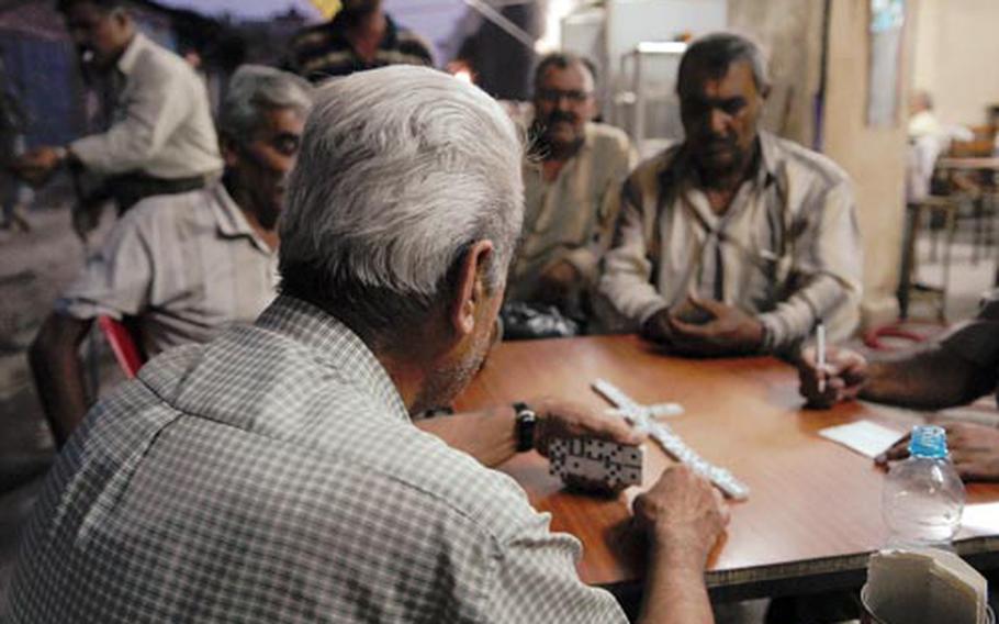 Iraqi men play dominoes in one of Kirkuk’s markets. The atmosphere in the markets and other areas is generally relaxed even though the province's status has not been resolved.