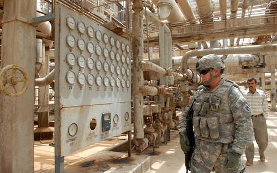Maj. John Bennett, a civil affairs officer with Company A, 418th Civil Affairs Battalion, walks past analog gauges at Northern Oil Co.’s Stabilization Plant 1 near Kirkuk. Although the plant was built in the 1940s and hasn’t been refurbished in 30 years, the company must rely on it for the majority of its oil processing because of attacks on a newer plant.
