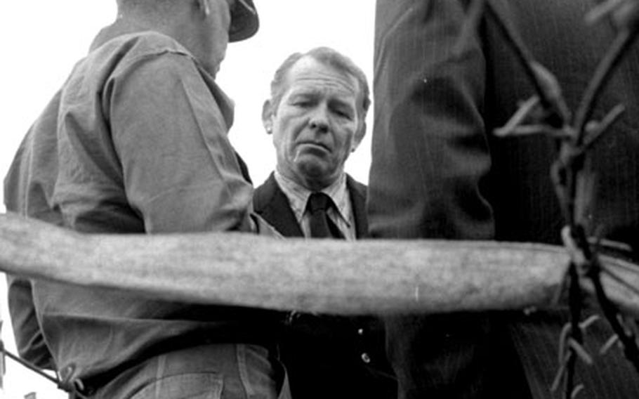 Presidential counselors Robert Finch, center, and Donald Rumsfeld talk with Col. Sidney S. Haszard, left, of the 3rd Brigade, 3rd Armored Division.