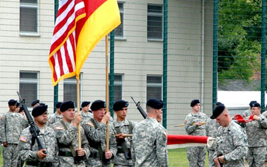 As one of their company guidons is unfurled behind them, Command Sgt. Maj. Bradley Houston (right), and Lt. Col. David Hurley Jr., uncase the 15th Engineer Brigade colors Wednesday during a reactivation ceremony on Conn Barracks in Schweinfurt, Germany.