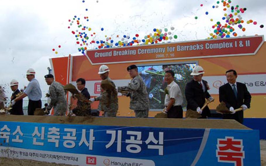 Officials from the U.S. Army and the Hanwha Construction and Engineering Corporation throw shovels of dirt during a groundbreaking ceremony Wednesday in Pyeongtaek.