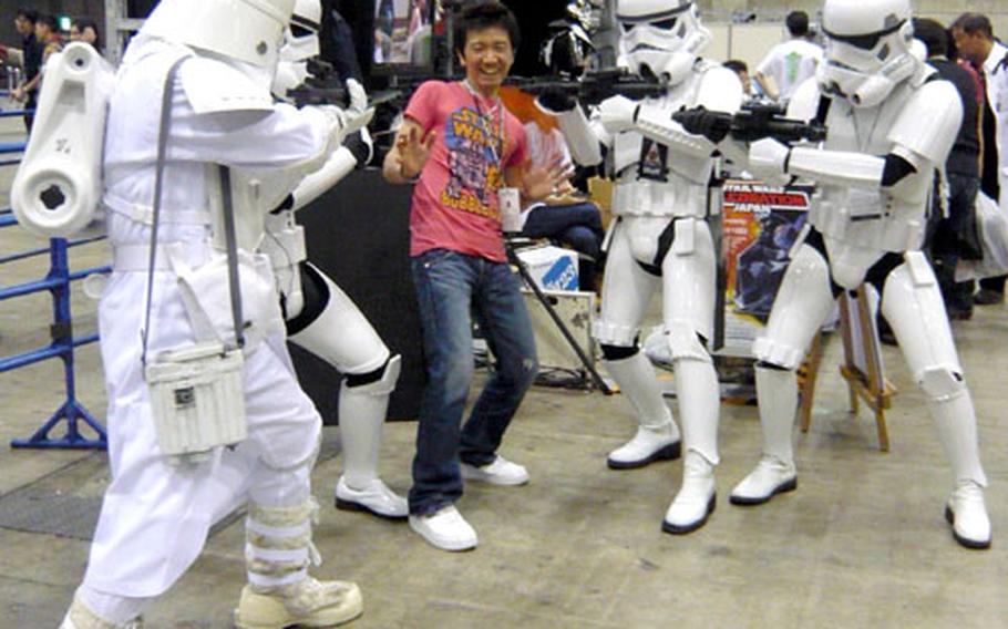 A fan poses with Storm Troopers for a photo opportunity Saturday during Star Wars Celebration Japan. The event runs through Monday at the Makuhari Messe convention center.