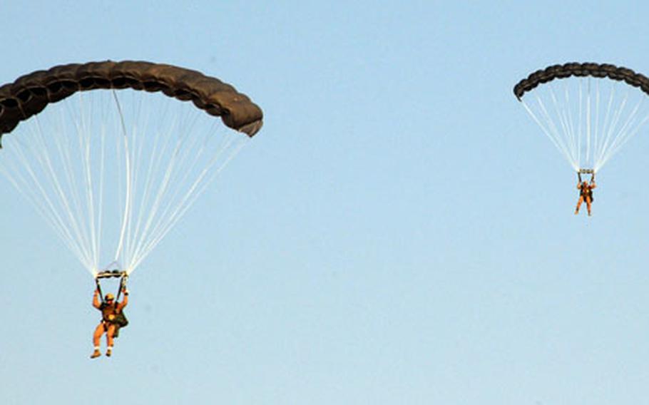 Marines with 3rd Reconnaissance Battalion line up one behind one another for landing in a drop zone on Al Asad Air Base in Anbar province, Iraq, last week. This was their second day of static line jumps -- in which their parachute is automatically released as they jump from an airplane -- using the Marine Corps' new multi-mission parachute system.