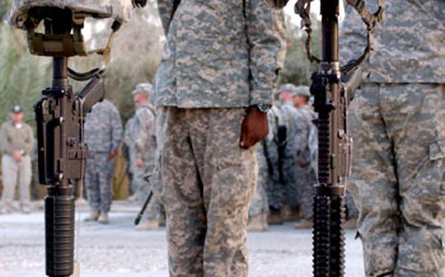 U.S. soldiers salute Monday during a memorial service honoring Staff Sgt. Alex Jimenez and Spc. Byron Fouty in Baghdad.