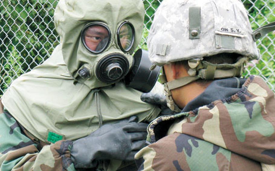 U.S. soldiers from the 4th Chemical Company prepares a South Korean 16th Chemical Battalion soldier during decontamination training Tuesday at Camp Hovey. The two units trained together for the first time in several years.