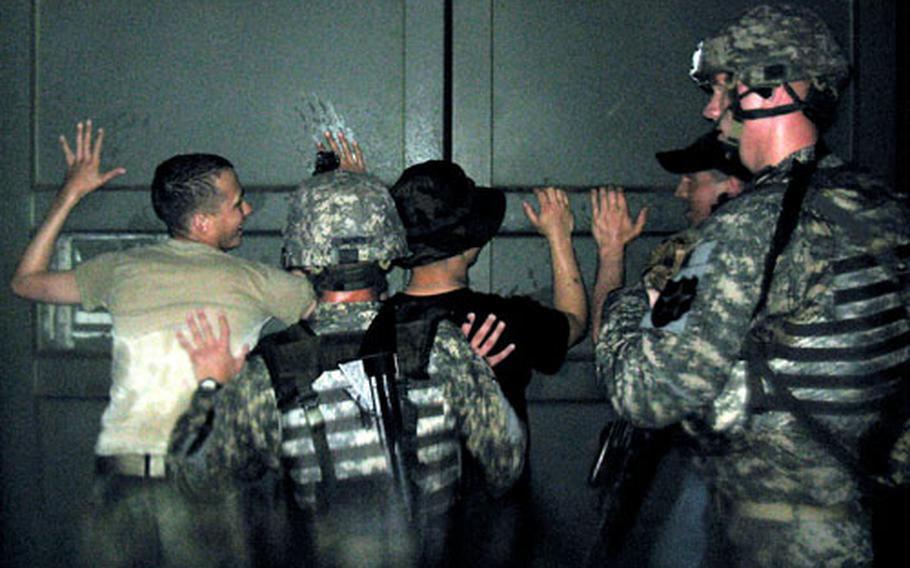 Bravo Company soldiers nab "suspected enemy fighters" during a firefight in a mock urban village Thursday at Camp Hovey.
