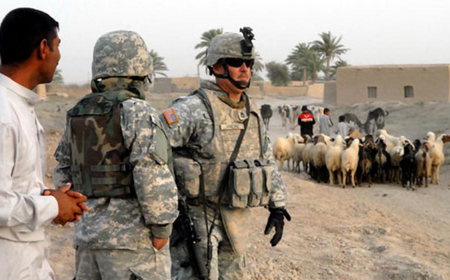 Sgt. 1st Class Sean Harding looks around Kharbul, Iraq, during a walk through the village July 19. Harding’s unit — Lion Battery, 2nd Squadron, 3rd Armored Cavalry Regiment — is living in small combat outposts near villages like Kharbul to maintain security in the area.